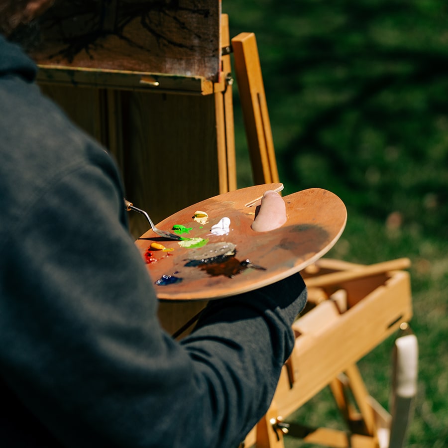 close up of artist Chris Gutierrez holding painting palette