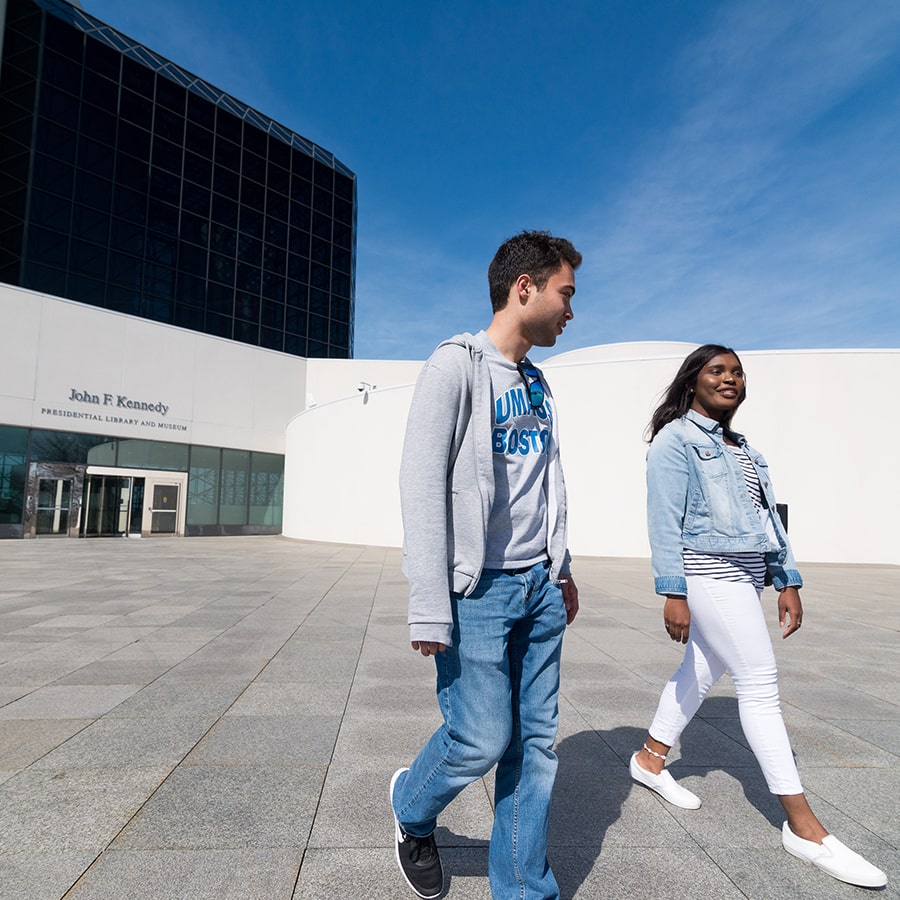 students walking on steps of JFK Library, Boston, MA