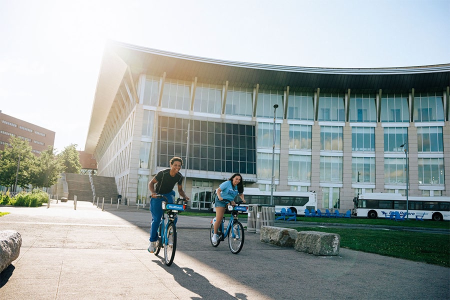 Students biking in front of Campus Center