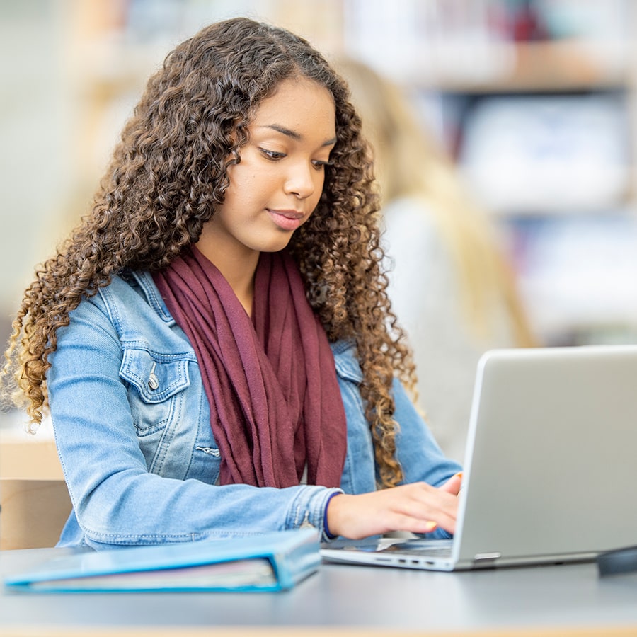 female student jean jacket at computer