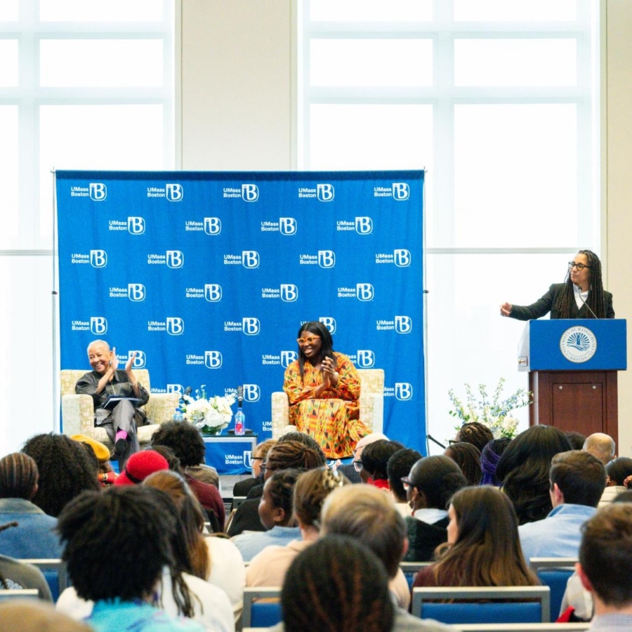 people on stage speaking at an event