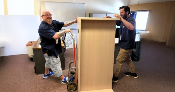 crew moving a desk