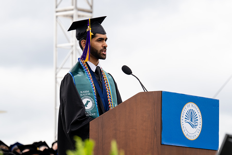 JFK award winner and 2025 Undergraduate Commencement Speaker Basim Naeem giving speech at podium on stage