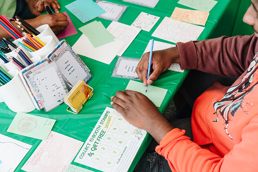 People writing at Walk with GRACE event