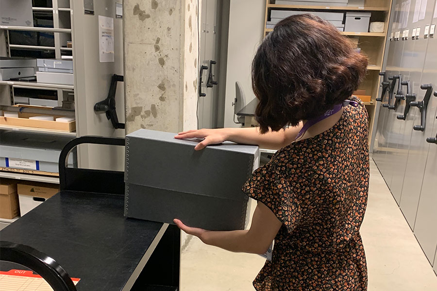 Leanne Navarro, works in historical records and preservation in the museum’s archives