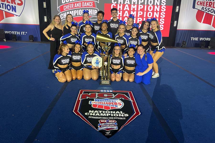 UMass Cheerleader NCA National Title Win students posing with Trophy