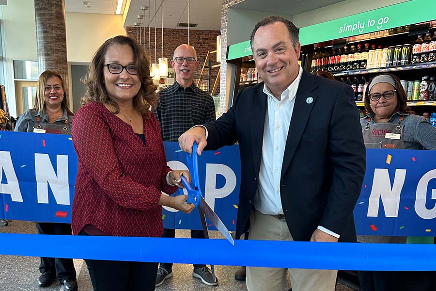 Hector and Miriam Morales Cutting Ribbon with Large Scissors