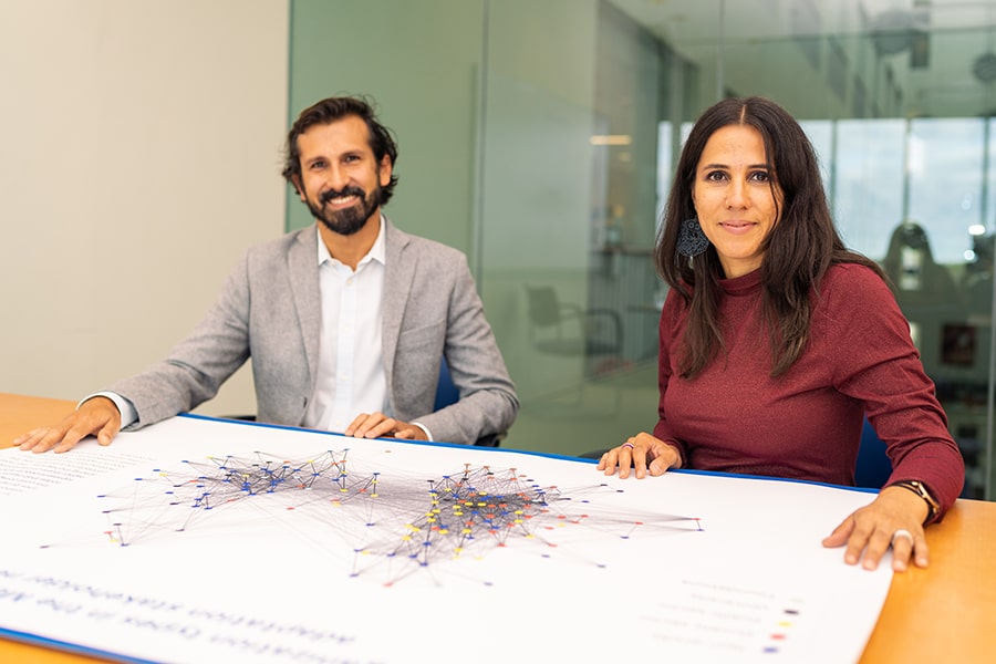 Antonio Raciti, PhD, and Rosalyn Negrón, PhD, with outputs from their research, “Connecting for Equitable Climate Adaptation: Mapping Stakeholder Relationships in Metro Boston